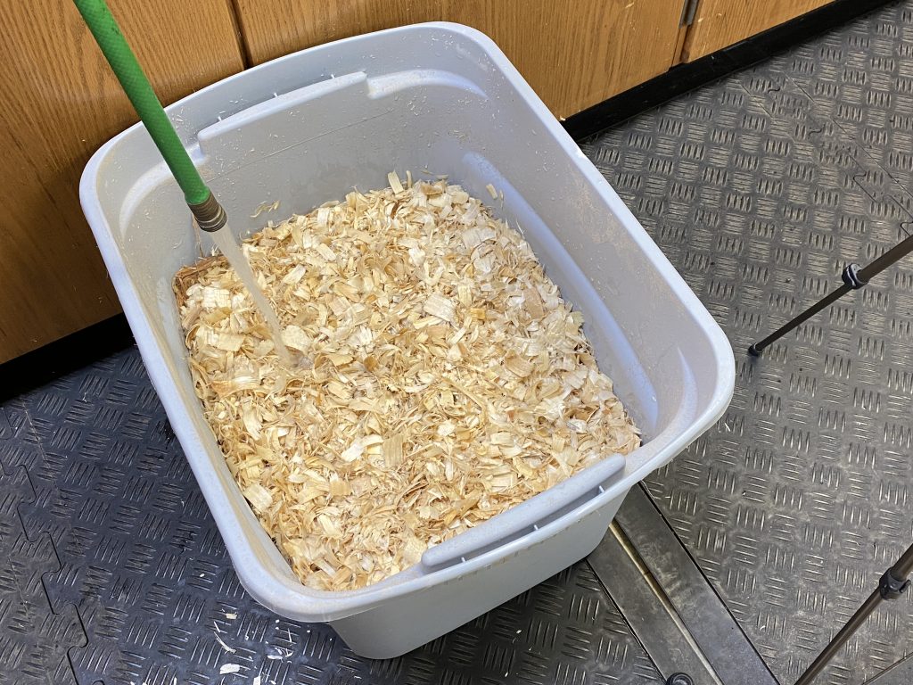 wood chips in hot water in a large container